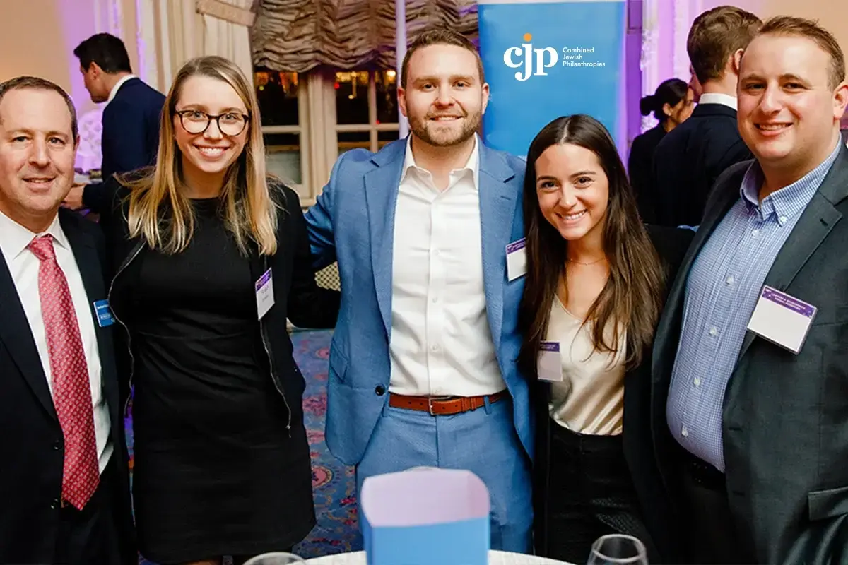 Jewish professional networks boston: Professionals gather and pose together during a Jewish business networking and community engagement event.