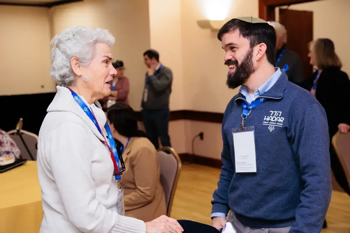 Jewish professional networks boston: Two community members engage in conversation during a Jewish professional networking and leadership gathering.