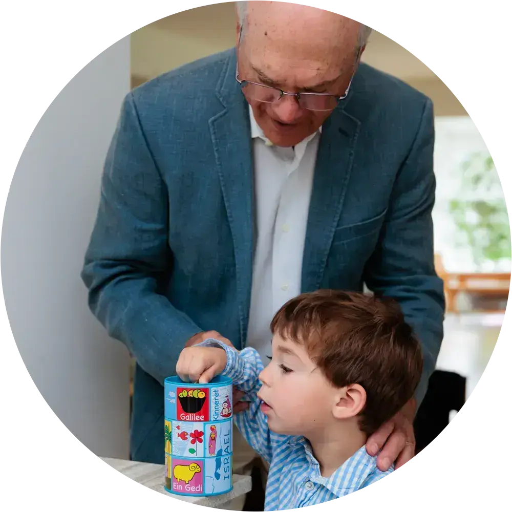 A grandparent and grandson spending time together, symbolizing the legacy of giving to the Acharai Leadership Program.