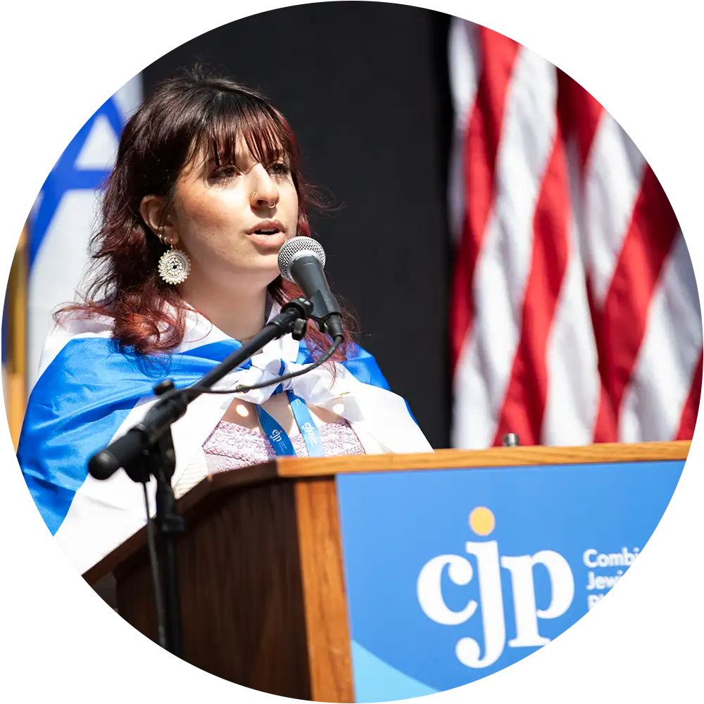 College student speaking at a campus rally, advocating for Jewish life and raising awareness about antisemitism